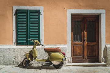 Poster Motor scooter in front of a house in Italy © Thomas A. Feller