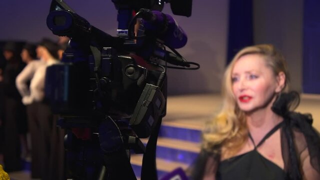 Woman fashion influencer talk on television interview, camera recording broadcast Spbd. Mature