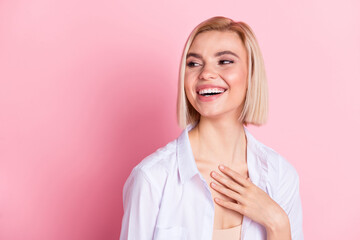 Photo of attractive cheerful young woman look empty space laugh joke comic isolated on pink color background