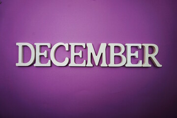 December alphabet letter with space copy on Purple background