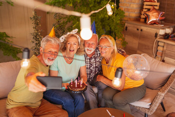 Senior friends taking a selfie at birthday party