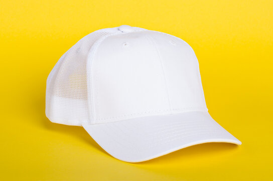 White Baseball Cap Mockup. Blank Trucker Hat Isolated On Yellow Background