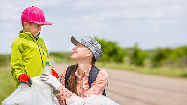 Family Picking Up Trash On A Sunny Spring Day