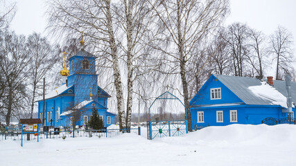 rural wooden Orthodox church among the trees
