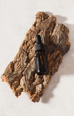 Serum for the skin of the face on the bark of a tree. Anti-aging cosmetic care. Copy space.
