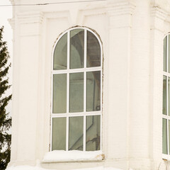 window in a white brick wall