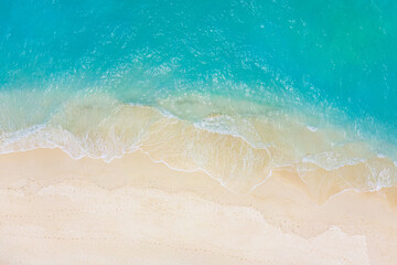 Fototapeta na wymiar Top view on coast waves on beach aerial view, crystal clear water. Stunning summer landscape, sunny tropical island shore. Seaside, idyllic nature Earth view. Stunning scenery, amazing view