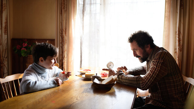 Portrait Of Poor Small Girl With Father Eating Indoors At Home, Poverty Concept.