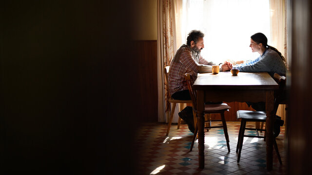 Portrait of poor mature couple talking indoors at home, poverty concept.