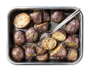 Oven baked  purple potatoes with herbs and salt in metal baking dish isolated on white background. Home cooking. Vegetarian, plant-based or vegan food concept. Top view.