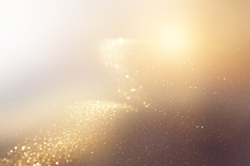 background of abstract gold and black glitter lights. defocused