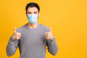 Protection against contagious disease, coronavirus, covid-19. Man wearing hygienic mask to prevent infection, airborne respiratory illness such as flu, 2019-nCoV. Isolated over yellow background