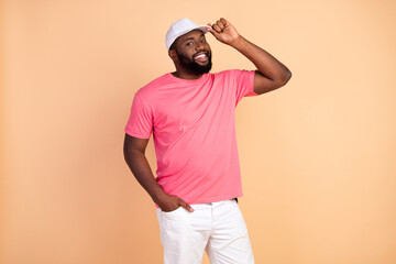 Photo portrait of man wearing casual outfit cap smiling happy isolated pastel beige color background