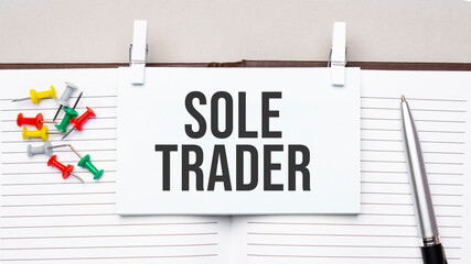 text sole trader on stickers on the diary with office tools
