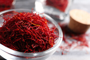 Fototapeta premium Dried saffron in glass bowl, closeup view