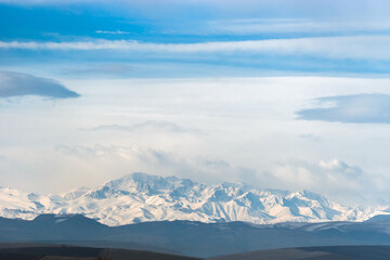 Snowy winter Caucasus mountains on the horizon. Kabardino-Balkaria, Russia.