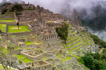 ruins of the ancient city of machu picchu in mystic fog 