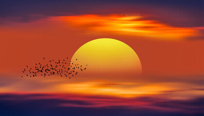 Silhouette of birds flying over sunset clouds with yellow sun