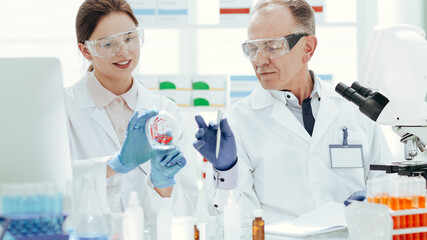 close up. scientists discussing samples sitting at a laboratory table.