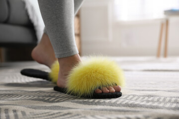 Woman wearing stylish soft slippers at home, closeup