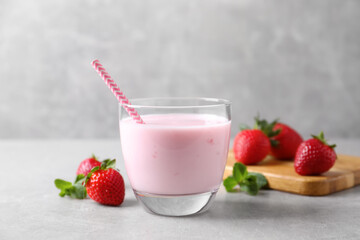Delicious strawberry drink on light grey table