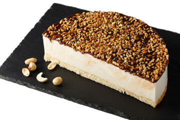 Half of New York style sprinkled with peanuts cheesecake isolated on a white background.