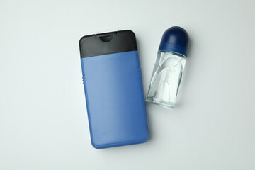 Bottle of shower gel and deodorant on white background