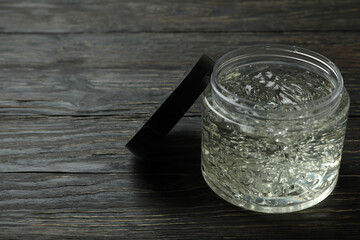Jar of styling gel on wooden table
