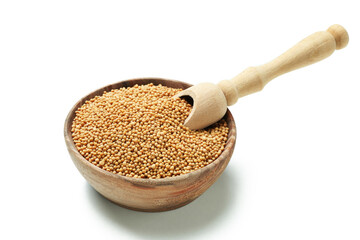 Bowl with mustard seeds and scoop isolated on white background