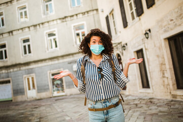 Fototapeta na wymiar New normal of traveler. Beautiful woman travel in holiday with backpack and wearing protection mask virus for safety trip.