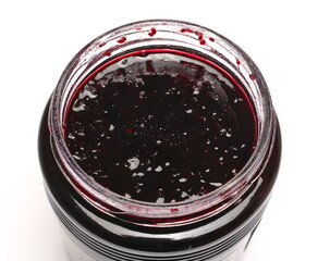 Blackcurrant jam in glass jar, marmalade isolated on white background
