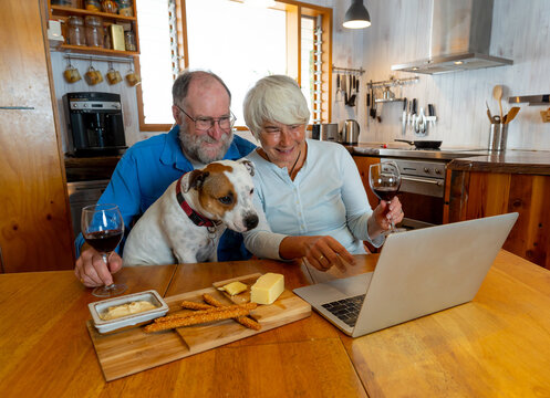 COVID-19 Stay safe, Stay Connected. Senior couple with pet dog video calling family and love ones