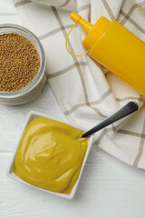Concept of sauce with mustard on white wooden table