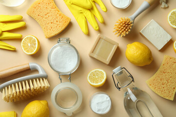 Cleaning concept with eco friendly cleaning tools and lemons on beige background