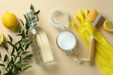 Cleaning concept with eco friendly cleaning tools and lemons on beige background