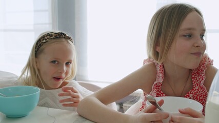 Two children eat healthy breakfast