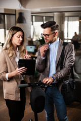 Colleagues in office. Businesswoman and businessman discussing work in office