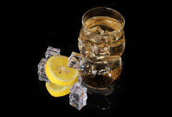 lemon ice tea with ice on black background 