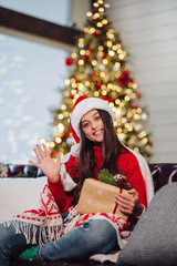 Obraz na płótnie Canvas Girl holding a Christmas present on New Years Eve.