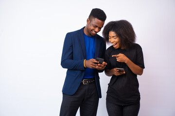 excited young man and woman viewing content on their phones feeling exited