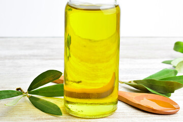 bottle of oil with fresh green leaves