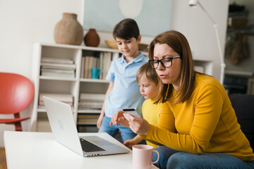 mother with kids shopping online from home
