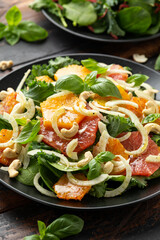 Fresh salad with fennel, orange, grapefruit, spinach and cashew nuts. healthy food.