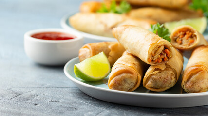 Fried spring rolls with sweet chili sauce and lime on plate - obrazy, fototapety, plakaty