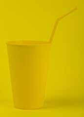 Yellow glass on a yellow background close-up.