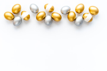 Silver and golden eggs isolated on white background. Easter decoration background. Top view