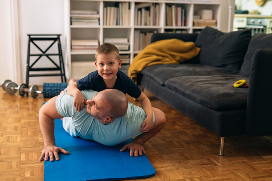 father and son exercise at home