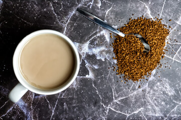 Coffee Cup and Instant Coffee Grains on Marble Background