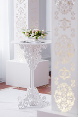 White carved round table for wedding ceremony. Elegant coffee table