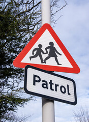 Red triangle patrol sign outside school Moreton Wirral February 2021